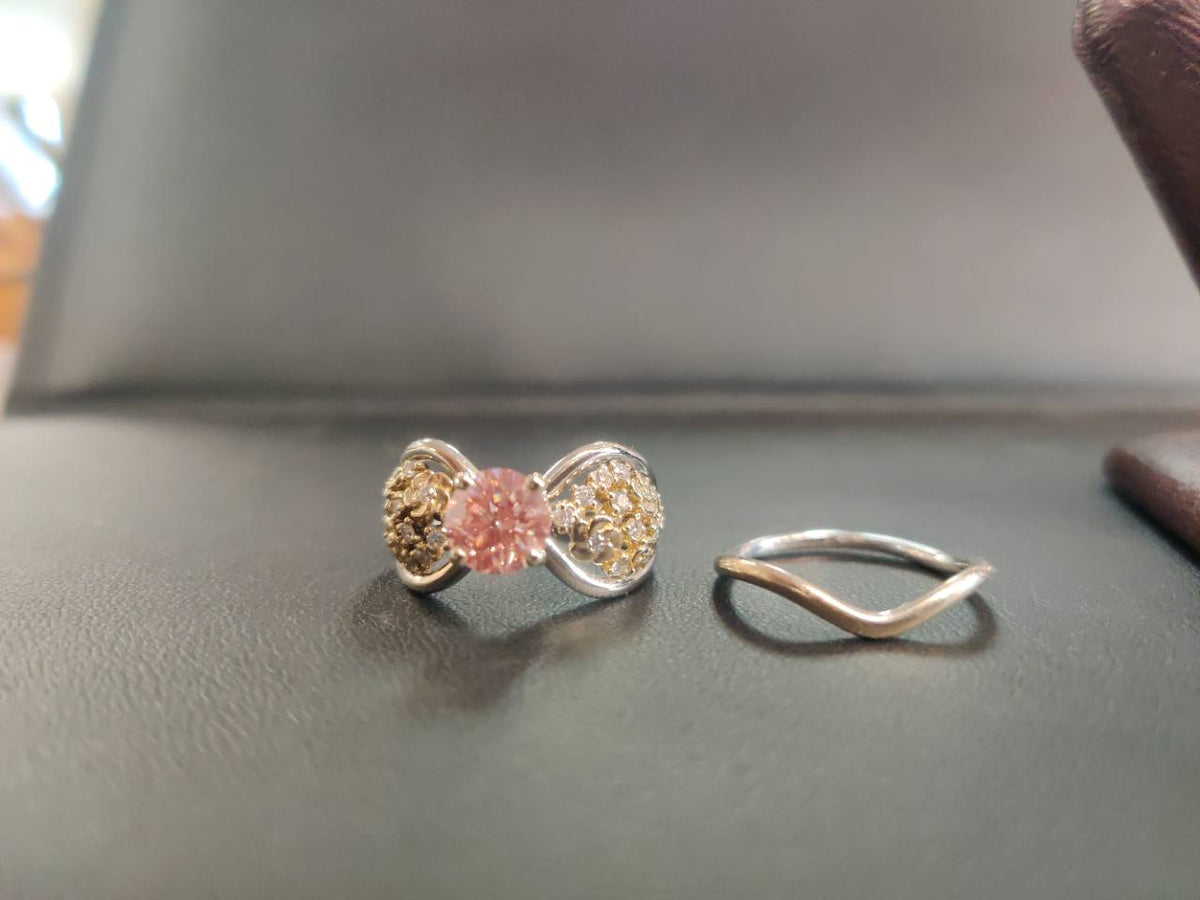 Finished custom pink center-stone ring with coordinating curved band